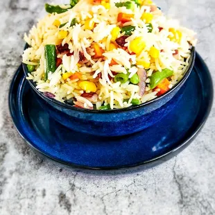 Jasmine rice cooked with an assortment of vegetables and seasoning.