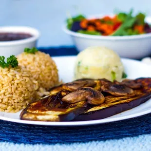 a plate of food with rice and vegetables