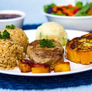 a plate of food with rice, meat, and vegetables