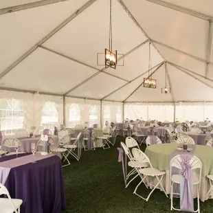 Tables inside wedding tent with your choice of color scheme.