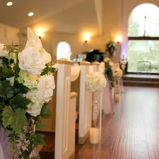 Gorgeous pew decorations with your choice of ribbon color, provided with venue.