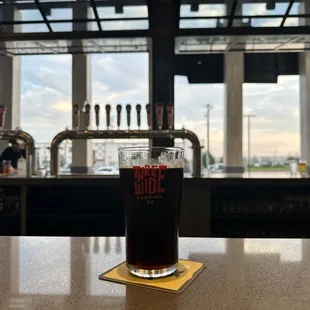 a pint of beer on a bar