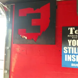 a red wall with a sign that says, i love you, stop inside