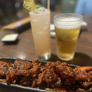 a plate of chicken wings and a drink