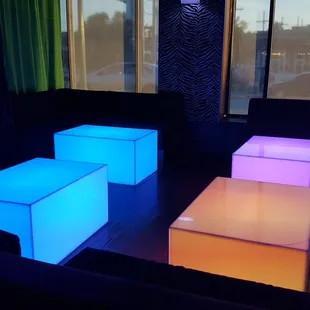 three illuminated cube tables in front of a window
