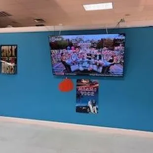 a blue wall with a flat screen tv