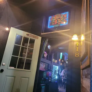 a neon sign above a door