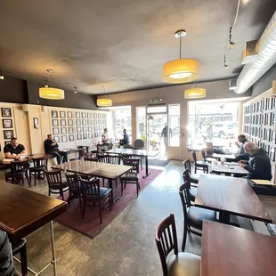 people sitting at tables in a coffee shop