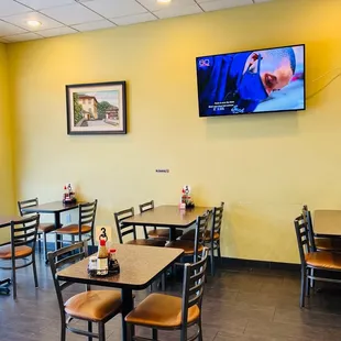 Dining area with flat screen monitor mounted on wall