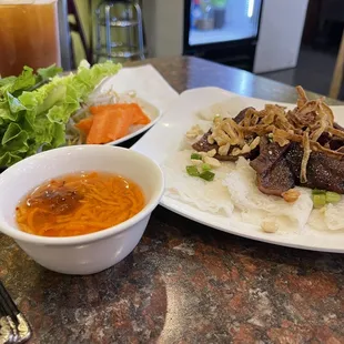 #67 Bahn Hoi Thit Nuong (fun flat vermicelli that&apos;s spongy and rolled up) which has a little bit more of the delicious char-grilled pork.