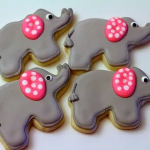 four decorated cookies with pink bows