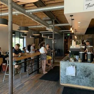 people sitting at tables in a coffee shop