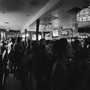 a crowd of people at a bar