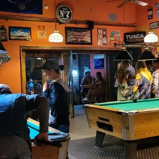 a group of people playing pool