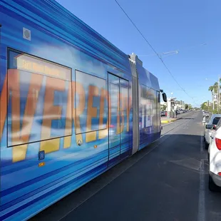 a blue and orange train on the tracks