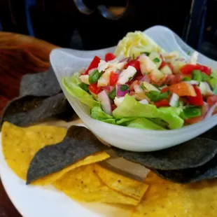 Bahamian style conch salad: Marinated diced conch w/ Pepers, Onion, Cucumber, Cilantro in Citrus Juices Served With Tortilla Chips. ONLY $10