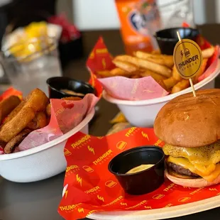 two baskets of fries and a cheeseburger