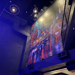 a man standing in front of a large screen