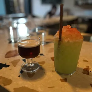 a glass of beer and a drink on a table