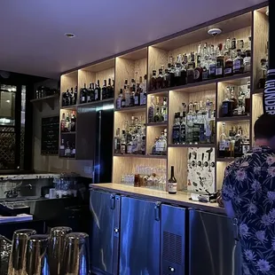 a man standing in front of a bar