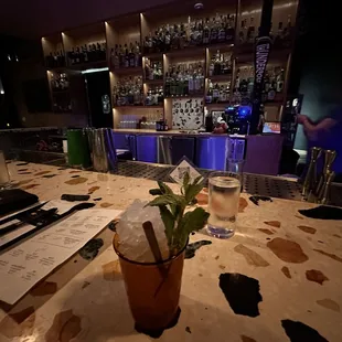 a table with a drink and menu