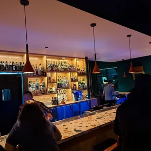 a group of people sitting at a bar