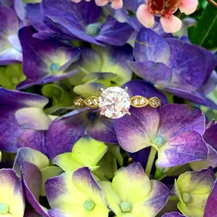 Vintage inspired engagement ring from Thurber Jewelers with floral background