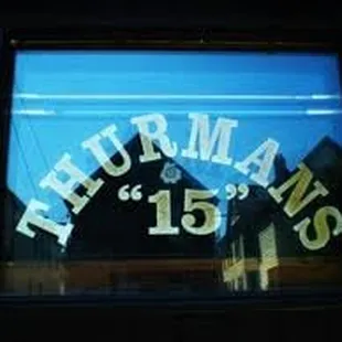 the reflection of the clock in the window