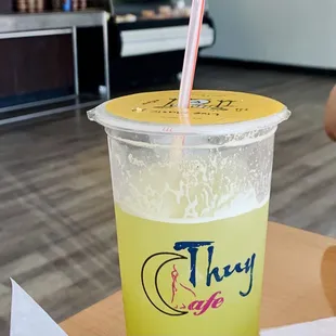 a drink in a plastic cup with a straw