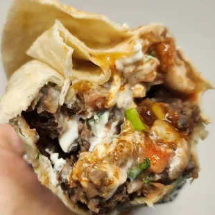 Carne asada burrito, extra meat, no rice.  $16.75. July 2023.