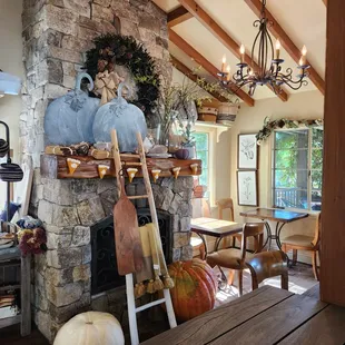 a stone fireplace and dining room