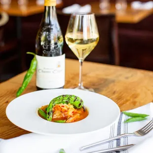 a plate of food and a glass of wine