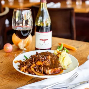 a plate of food and a glass of wine