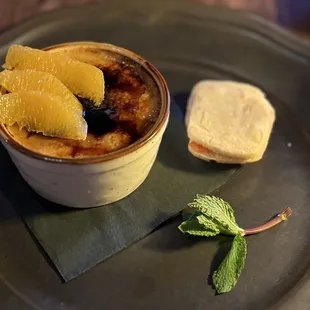 a plate of food with bread and orange slices