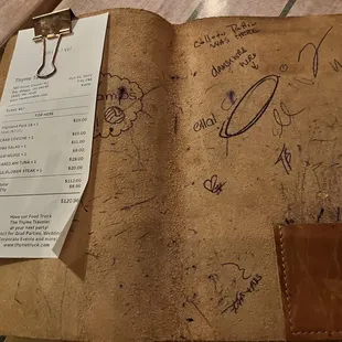 a notepad with a receipt on it