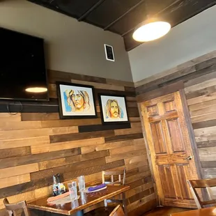 a dining room with a tv mounted on the wall