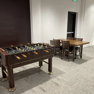 a foosball table and chairs in a room