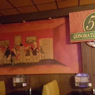 a painting of a group of people sitting at a table