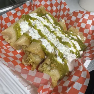 Tamales de pollo preparados con crema, queso fresco y salsa verde.
