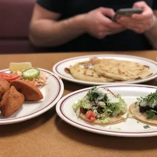 Carne asada and pulled pork tacos, papusas, and pasteles (pork, greenbeans, carrots, and potatoes in a fried taco).