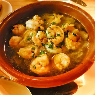 a bowl of shrimp soup on a plate