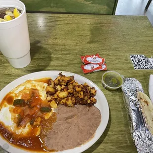 Huevos Rancheros with papa's &amp; chorizo, flour tortillas and green salsa and a large sweet tea