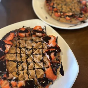 Churro waffle with strawberries and chocolate sauce