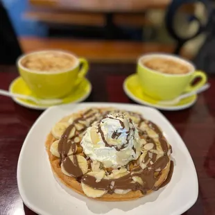 a waffle topped with whipped cream and chocolate