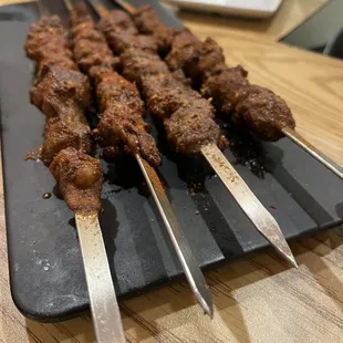 skewered meat on a cutting board