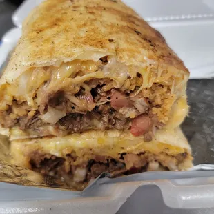 a burrito with meat and cheese