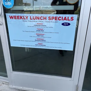 Front door of restaurant which clearly states hours of lunch special.