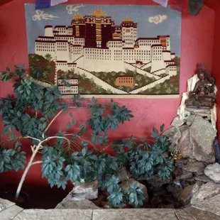 a potted plant in front of a mural