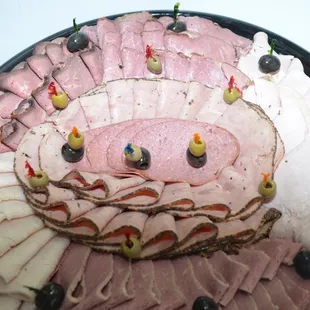 a platter of ham and olives