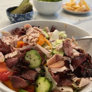Smoked turkey and pastrami on top of a salad makes a delicious and healthy lunch!